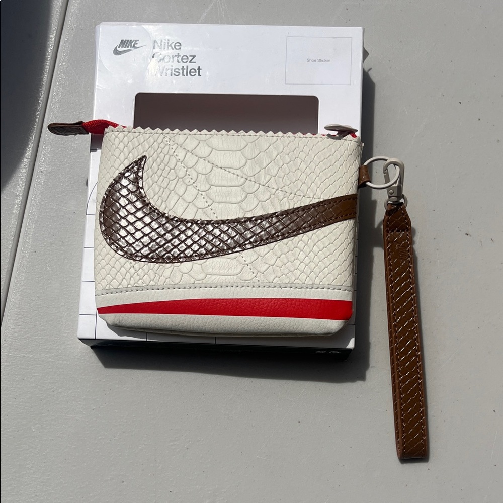 Nike Cream Wristlet with Brown Swoosh and Red Accent